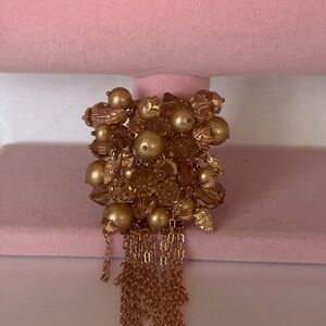 Vintage-style tassel brooch, characterized by its domed cluster of beads